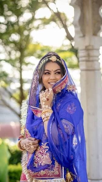 Royal blue ethnic attire portrait framed by carved marble pillars