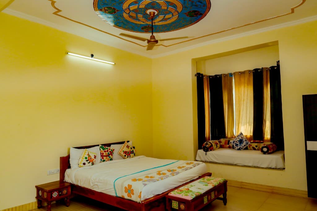 Family Deluxe Room bedroom featuring hand-painted ceiling artwork