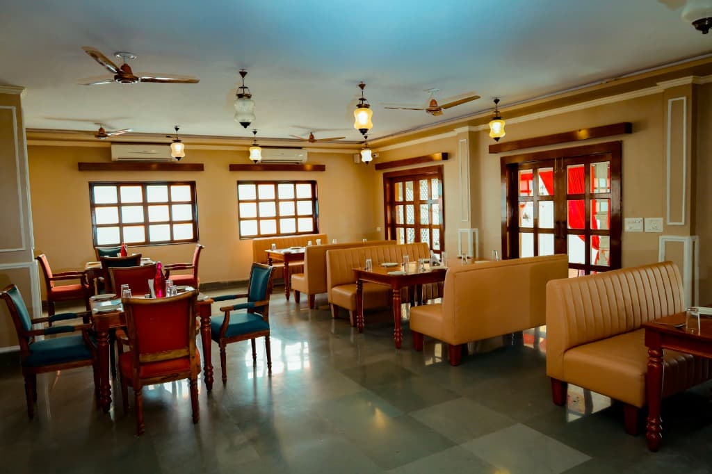 Royal Dining Hall indoor dining layout with comfortable tan leather booth seating and wooden tables