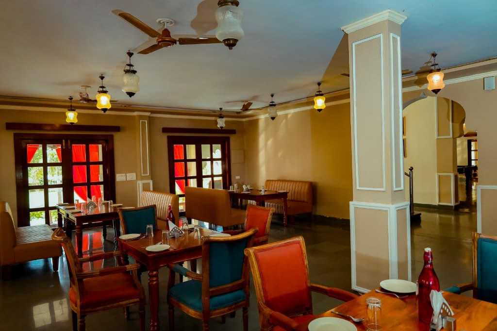 Royal Dining Hall perspective showing carved columns, hanging lanterns, and french glass doors